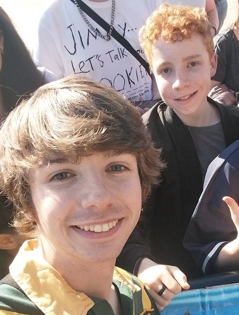 Young Eli Searle outdoors with Karl Jacobs — sunny selfie together